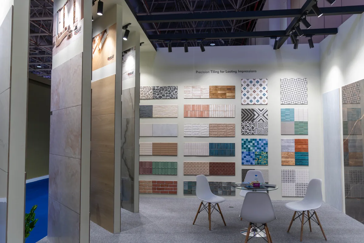 The ORKAY design studio — surface designs on screen, full-size slab samples on racks